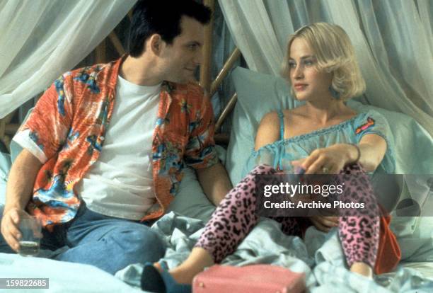 Christian Slater sits in bed with Patricia Arquette in a scene from the film 'True Romance', 1993.