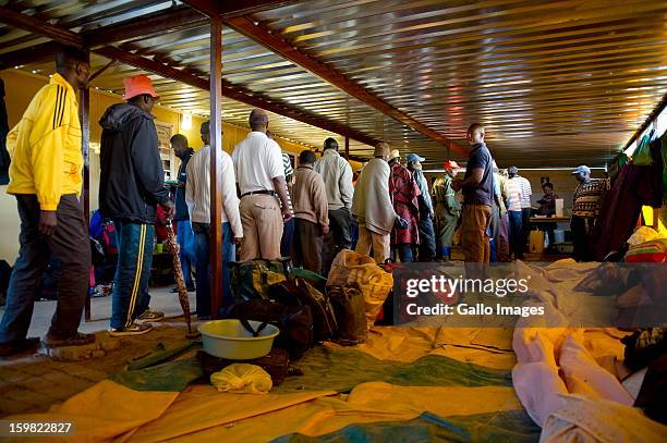 Group of mineworkers waiting for food at a church on January 17, 2013 in Carltonville, South Africa. About 80 miners found themselves stranded and...