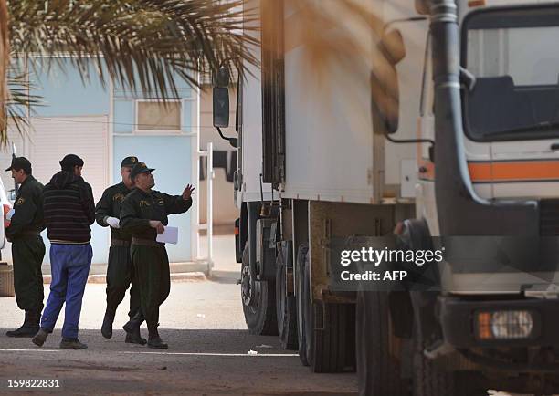 Algerian security personnel monitor as they remove body bags of victims, that were killed during the hostage crisis at a desert gas plant in...