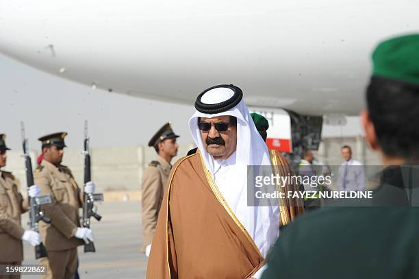 The Emir of Qatar Sheikh Hamad bin Khalifa al-Thani reviews the royal honor guard upon his arrival at Riyadh airport to attend the third Arab...