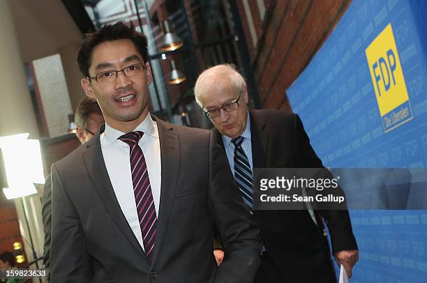 Philipp Roesler , Chairman of the German Free Democrats , and FDP Bundestag faction leader Rainer Bruederle depart after speaking to the media to...