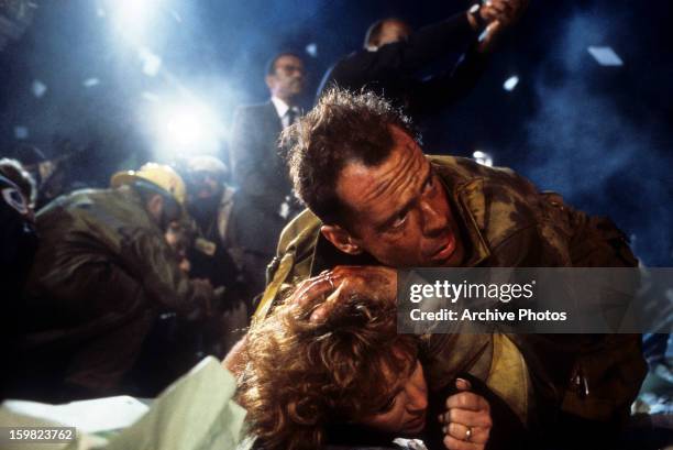 Bonnie Bedelia is held down by Bruce Willis in a scene from the film 'Die Hard', 1988.