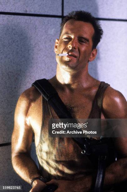 Bruce Willis with cigarette in a scene from the film 'Die Hard', 1988.