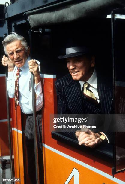 Burt Lancaster and Kirk Douglas ride a train in a scene from the film 'Tough Guys', 1986.