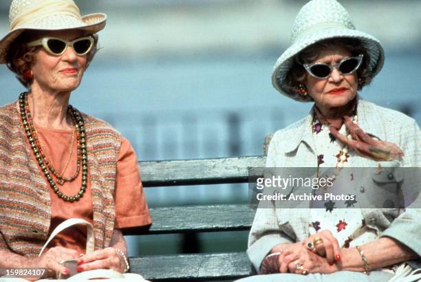 Sylvia Sidney sits on a bench in a scene from the film 'Used People', 1992.