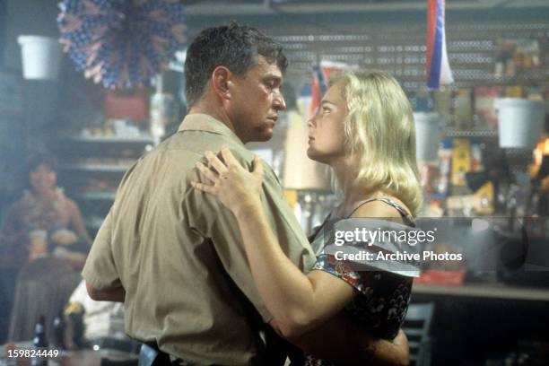 Tom Berenger and Erika Eleniak dancing in a scene from the film 'Chasers', 1994.