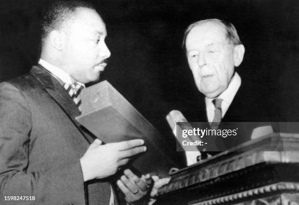 The US clergyman and civil rights leader Rev. Martin Luther King receives the 1964 Nobel peace prize from the chairman of the Nobel committee Gunnar...