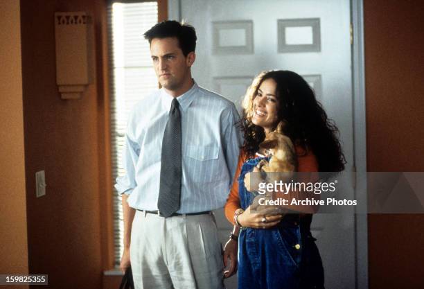 Matthew Perry and Salma Hayek enter a home in a scene from the film 'Fools Rush In', 1997.