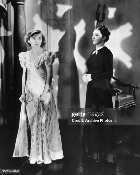 Joan Fontaine is looked at by Judith Anderson in a scene from the film 'Rebecca', 1940.