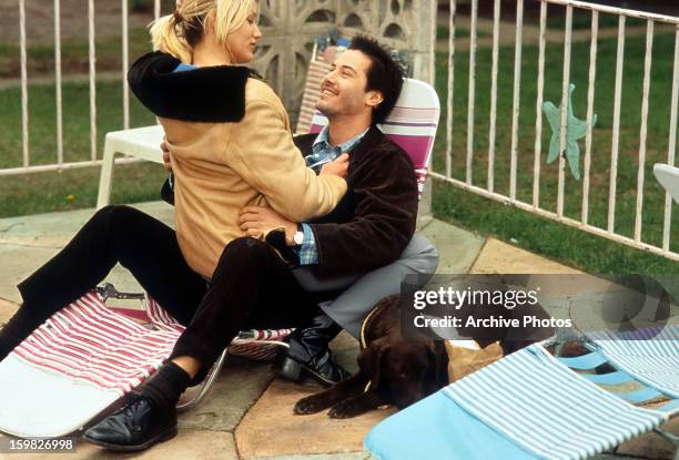 Cameron Diaz sitting on the lap of Keanu Reeves in a scene from the film 'Feeling Minnesota', 1996.