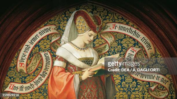 Medieval lady reading the poem Tristan und Isolde, by the poet Gottfried von Strassburg, the inscriptions shows the first line of the poem,...