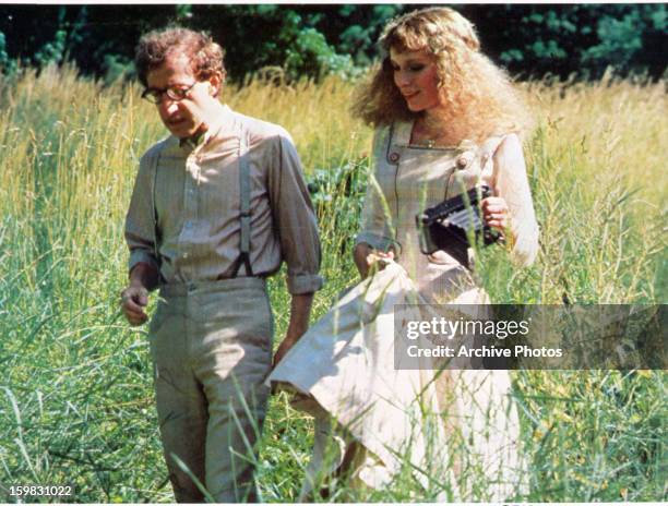 Woody Allen walks with Mia Farrow in a field in a scene from the film 'A Midsummer Night's Sex Comedy', 1982.