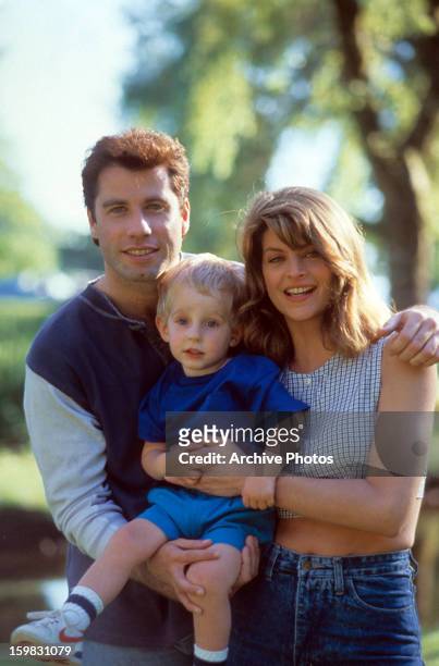 John Travolta and Kirstie Alley holding a child in a scene from the film 'Look Who's Talking', 1989.
