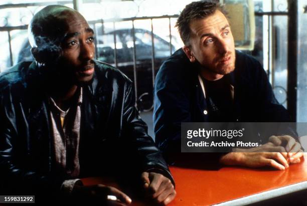 Tupac Shakur and Tim Roth sit at a counter in a scene from the film 'Gridlock'd', 1997.