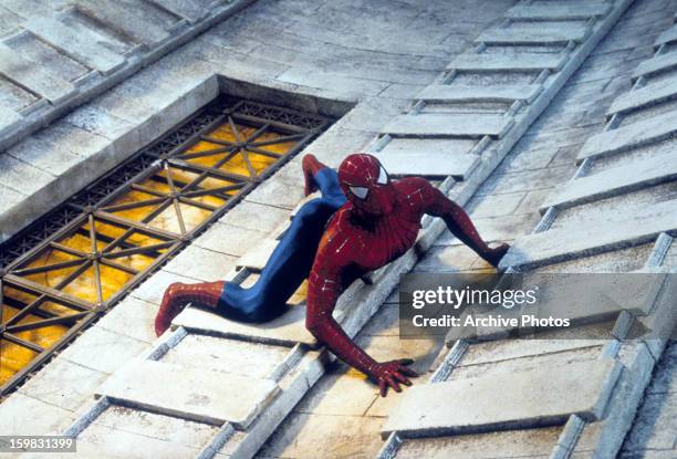 Spiderman climbing a tall building in a scene from the film 'Spiderman', 2002.