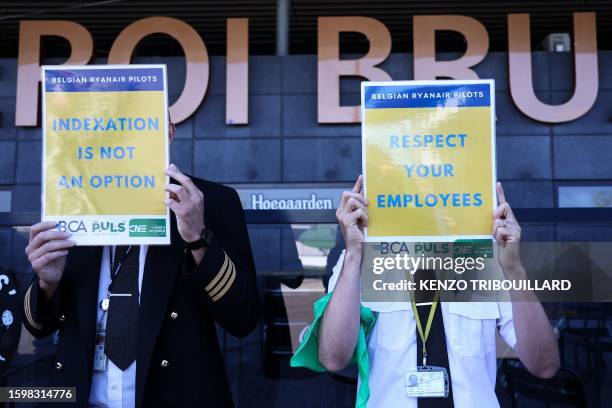 Ryanair pilots hold placards at the Charleroi Airport, in Charleroi on August 14, 2023 during a Ryanair pilots' strike over working conditions.