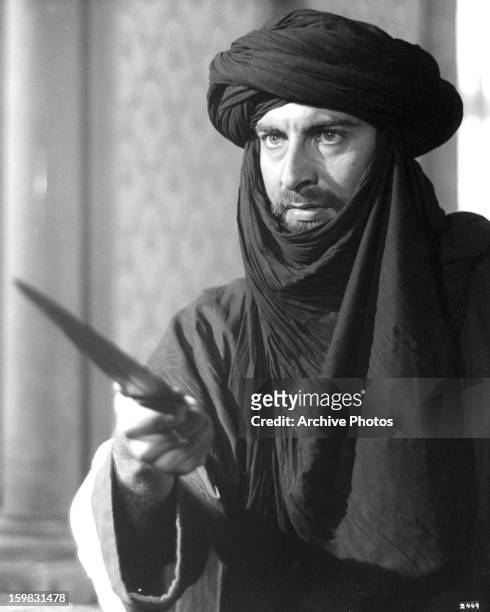 Kabir Bedi holding dagger in a scene from the film 'Ashanti', 1979.