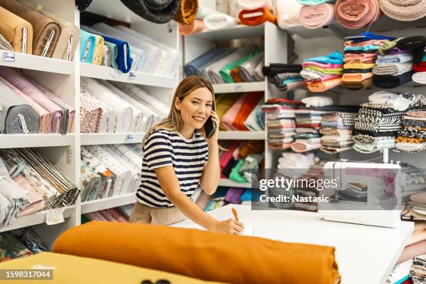 empowered woman selling fabrics - textile stock pictures, royalty-free photos & images