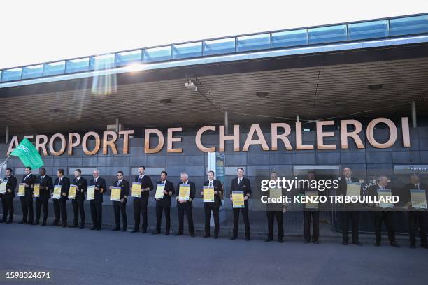 Ryanair pilots hold placards at the Charleroi Airport, in Charleroi on August 14, 2023 during a Ryanair pilots' strike over working conditions.