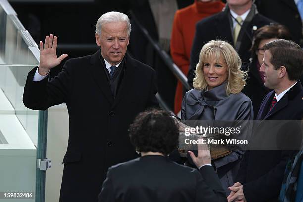 Vice President Joe Biden is sworn in by Supreme Court Justice Sonia Sotomayor as wife Dr. Jill Biden and son Beau Biden look on during the...