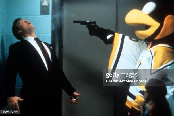 Man is shot by the mascot in a scene from the film 'Sudden Death', 1995.