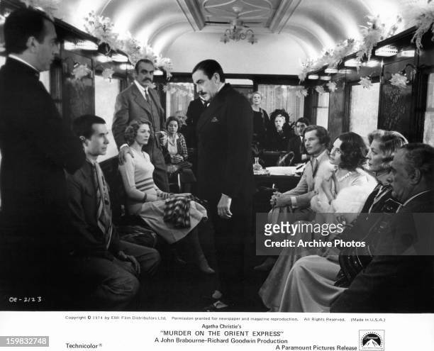 Albert Finney questions passengers in a scene from the film 'Murder On The Orient Express', 1974.