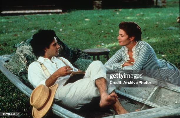 Adrian Pasdar sits in a boat and talks to Kelly McGillis in a scene from the film 'Grand Isle', 1991.