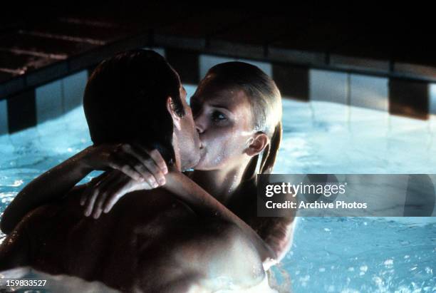 Natasha Henstridge in a swimming pool engaged in a kiss in a scene from the film 'Species', 1995.