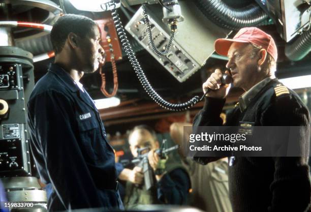 Gene Hackman and Denzel Washington being held at gun point in the control room in a scene from the film 'Crimson Tide', 1995.