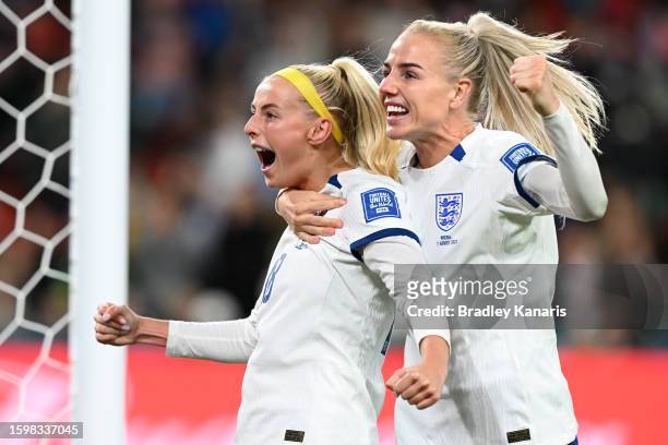 Chloe Kelly of England celebrates with teammate Alex Greenwood after scoring her team's fifth and winning penalty in the penalty shoot out during the...