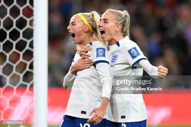 Chloe Kelly of England celebrates with teammate Alex Greenwood after scoring her team's fifth and winning penalty in the penalty shoot out during the...