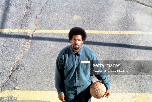 Denzel Washington holds a basketball in a scene from the film 'He Got Game', 1998.
