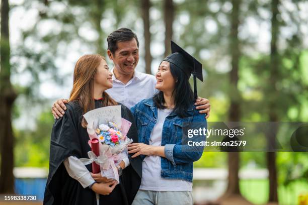 shared achievement: celebrating our daughter's graduation day - father daughter college stock pictures, royalty-free photos & images