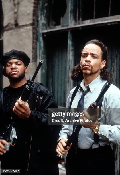 Ice Cube and Ice-T holding guns in a scene from the film 'Trespass', 1992.