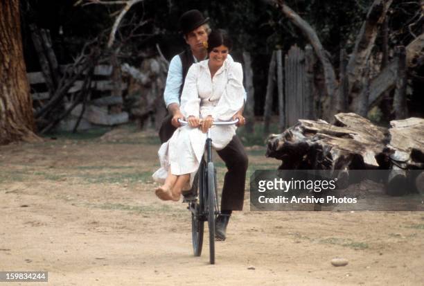 Paul Newman and Katharine Ross double riding on a bicycle in a scene from the film 'Butch Cassidy and the Sundance Kid', 1969.
