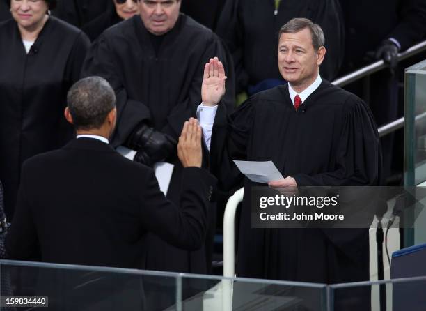 President Barack Obama is sworn in during the public ceremony by Supreme Court Chief Justice John Roberts during the presidential inauguration on the...