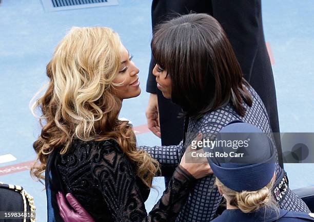 First lady Michelle Obama greets singer Beyonce after she performs the National Anthem during the public ceremonial inauguration on the West Front of...
