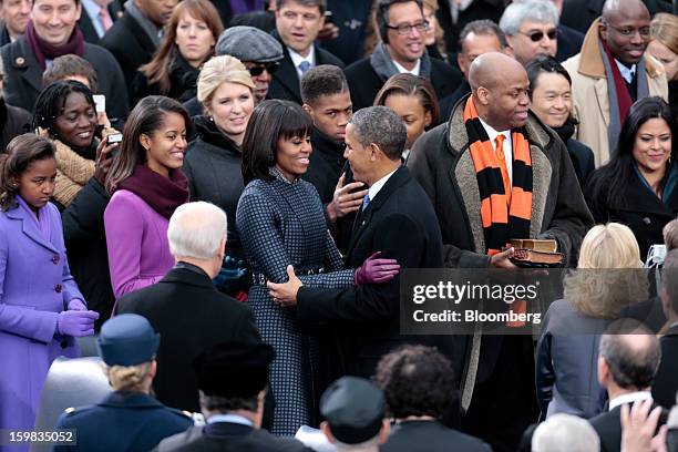 Sasha Obama, left and Malia Obama, second from left, watch as first lady Michelle Obama and U.S. President Barack Obama embrace at the Capitol during...