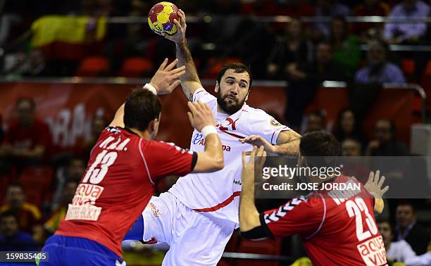 Spain's centre back Joan Canellas vies with Serbia's left back Momir Ilic and Serbia's centre back Nenad Vuckovic during the 23rd Men's Handball...