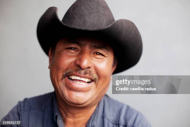 happy mexican man wearing a cowboy hat. - mexican mustache stock pictures, royalty-free photos & images