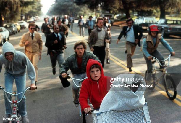 Henry Thomas riding with ET in his bike in a scene from the film 'E.T. The Extra-Terrestrial', 1982.