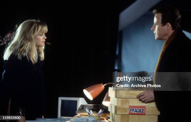 Goldie Hawn looking over at John Heard in a scene from the film 'Deceived', 1991.