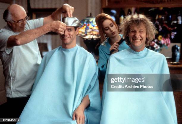 Jim Carrey and Jeff Daniels getting their hair cut in a scene from the film 'Dumb & Dumber', 1994.