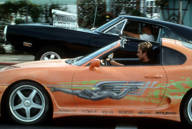 Vin Diesel and Paul Walker racing against each other in a scene from the film 'The Fast And The Furious', 2001.