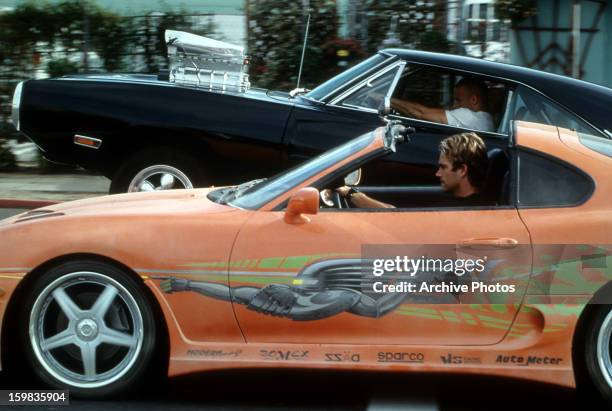 Vin Diesel and Paul Walker racing against each other in a scene from the film 'The Fast And The Furious', 2001.