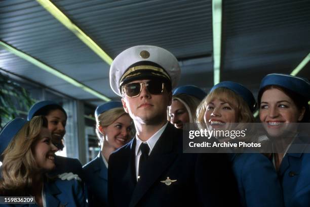 Leonardo DiCaprio with airline stewardess surrounding him in a scene from the film 'Catch Me If You Can', 2002.