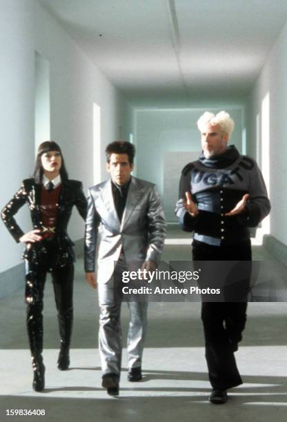 Ben Stiller walking down a hallway with Milla Jovovich and Will Ferrell in a scene from the film 'Zoolander', 2001.