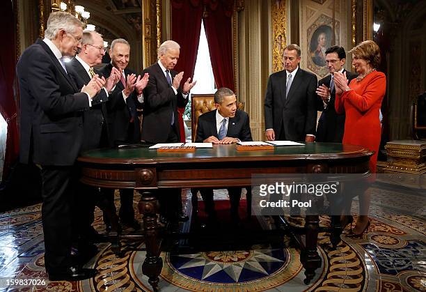 President Barack Obama is applauded by Senate Majority Leader Sen. Harry Reid , Sen. Lamar Alexander , Sen. Chuck Schumer , Vice President Joe Biden,...