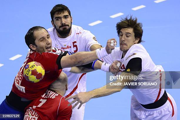 Serbia's pivot Alem Toskic vies with Spain's right back Jorge Maqueda and Spain's left back Viran Morros during the 23rd Men's Handball World...