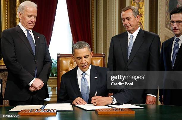 President Barack Obama signs a proclamation to commemorate the inauguration, entitled a National Day of Hope and Resolve, as Vice President Joe...